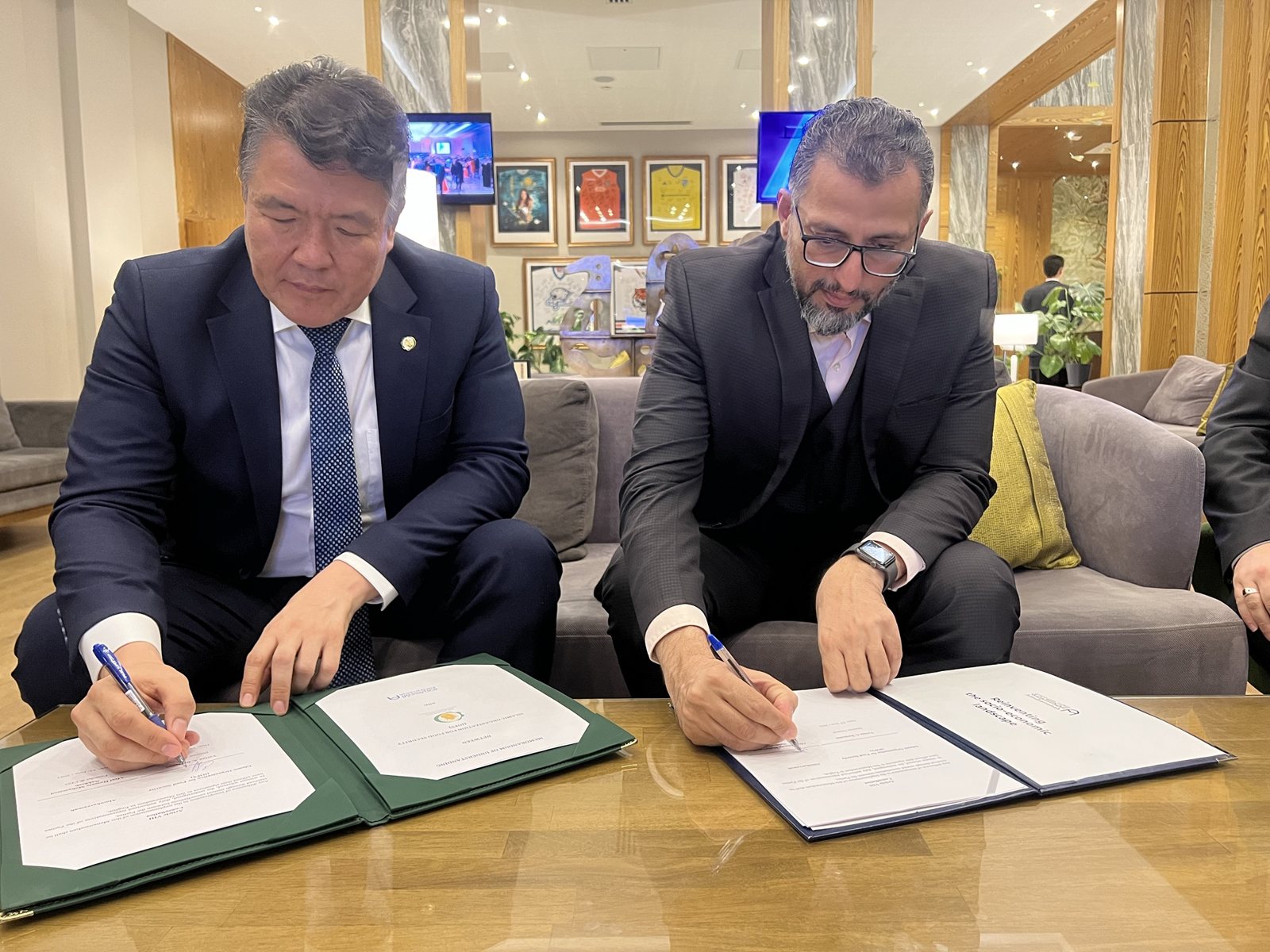 Signing the IOFS–Al Mukarramah MoU with IOFS Director General Yerlan Baidaulet, June 2023